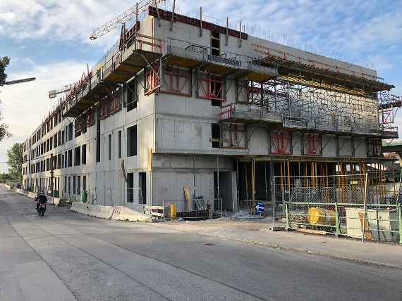 You can see a building consisting of 4 floors of raw concrete, which is still missing the windows.