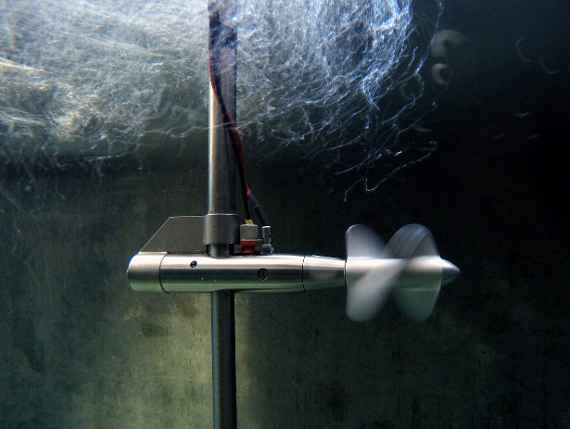A small current-meter with a propeller submerged in water, the body of which is attached to the thrust tube and rod. The propeller rotates (during the ride), above it creates a water vortex due to the fixed rod. Also, two cables are connected attached to the body.