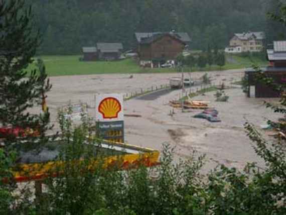 Bregenzerache, flood August 2005, flooded road. A flooded gas station, in the background are three houses that were not affected.