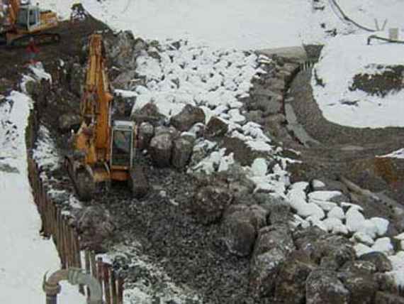 Revetment of the ramp base, an excavator is there and there is snow almost everywhere.