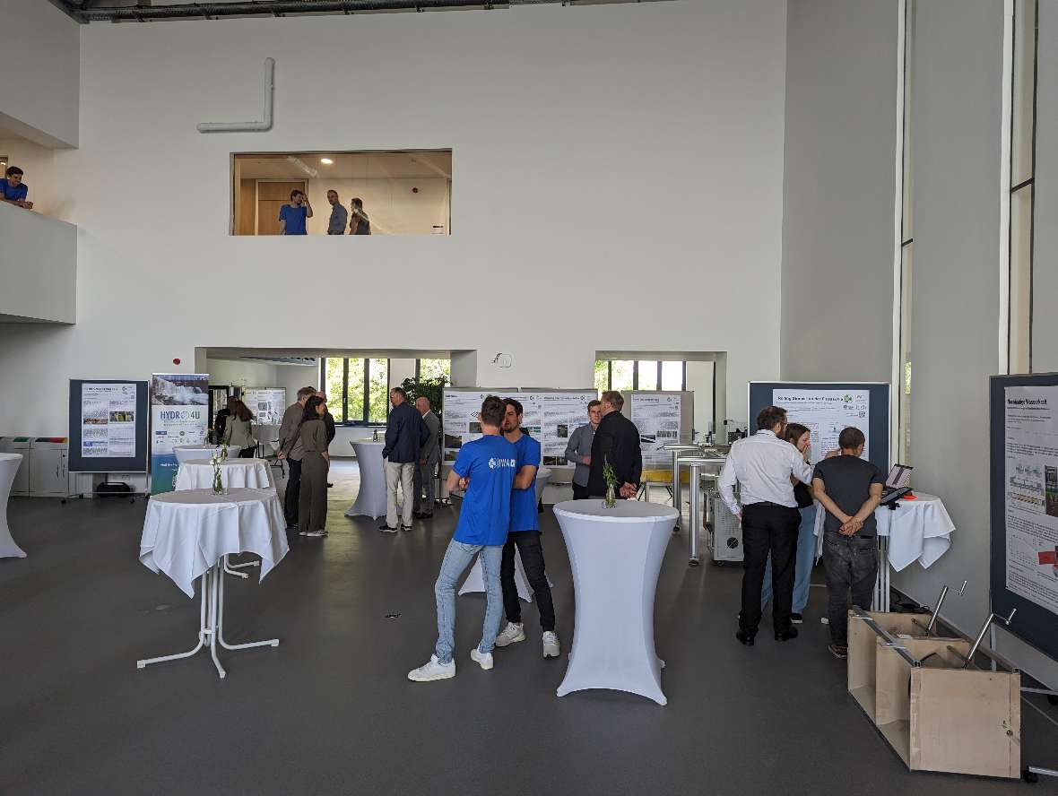 in the Public Lab, interested people look at the displayed posters on research projects