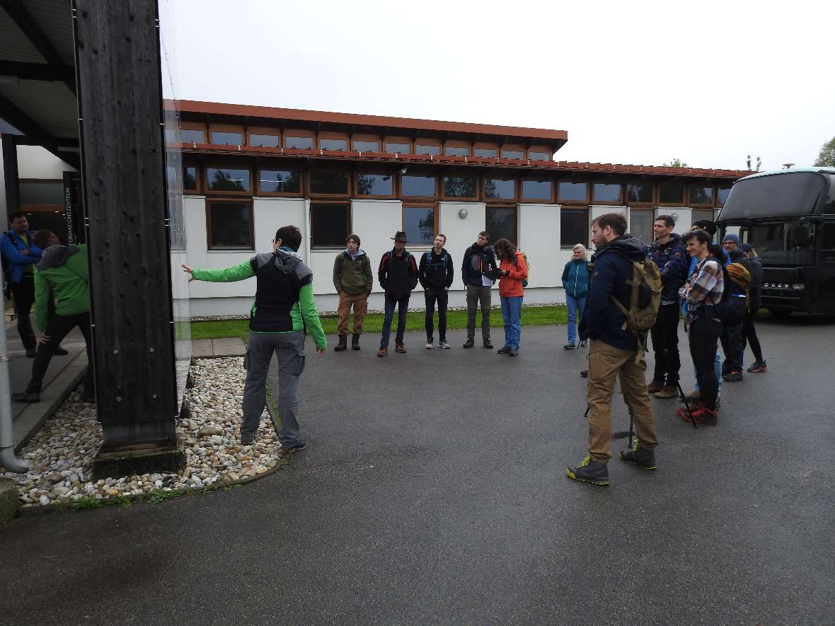 Das Seminar wurde als naturkundliche Exkursion unter Führung einer Rangerin des Nationalparks Neusiedler See abgehalten. Die Teilnehmer:innen haben sich vor dem Gebäude versammelt und folgen gespannt den Worten des Vortragenden.
